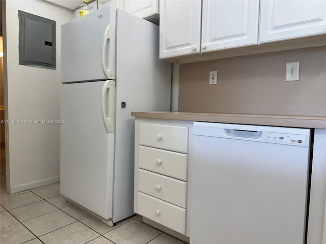 kitchen featuring electric panel, light tile patterned floors, white cabinets, and white appliances