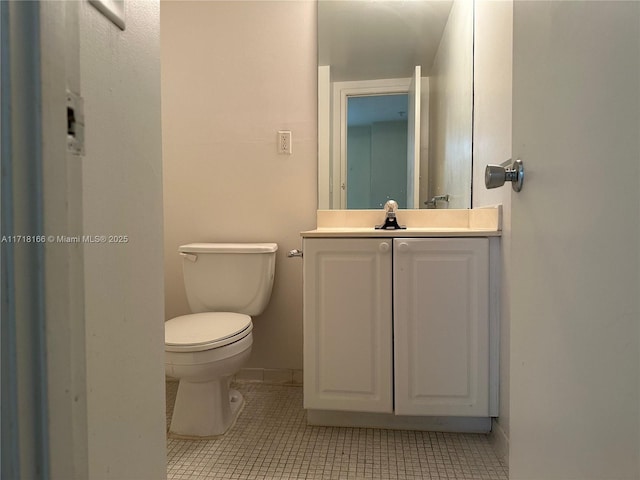 bathroom featuring tile patterned flooring, vanity, and toilet