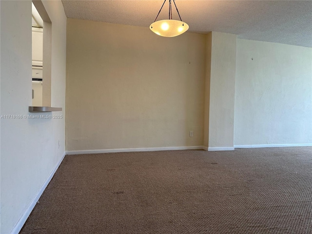 carpeted spare room featuring a textured ceiling