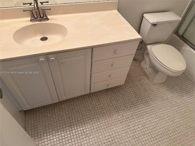 full bathroom with tile patterned floors, toilet, vanity, and combined bath / shower with glass door