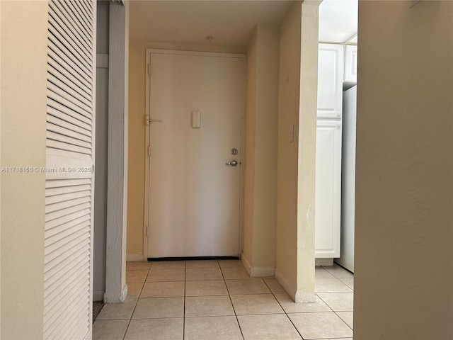 hall with light tile patterned floors