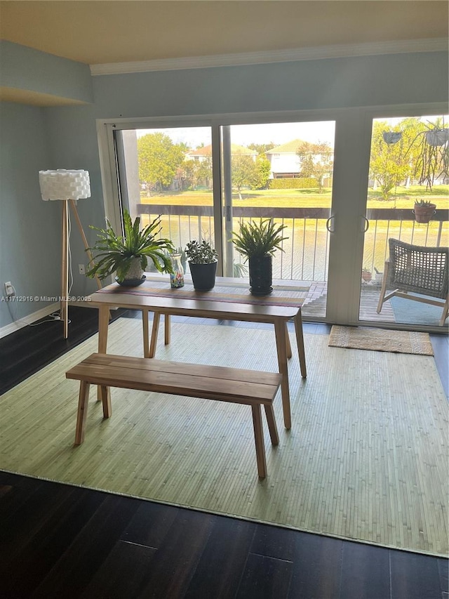 dining room featuring crown molding and hardwood / wood-style floors