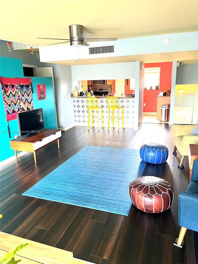 sitting room with wood-type flooring