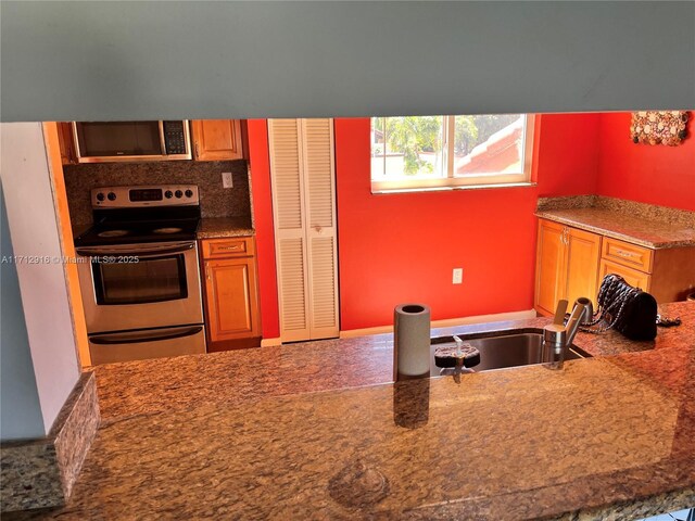 kitchen with dark stone countertops and sink