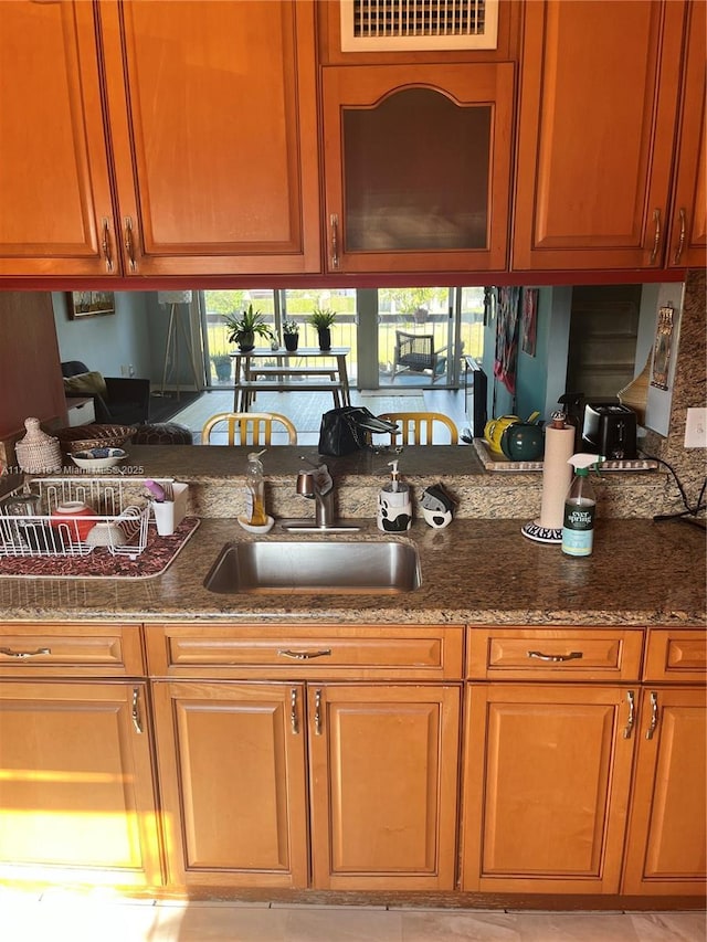 kitchen with dark stone countertops and sink