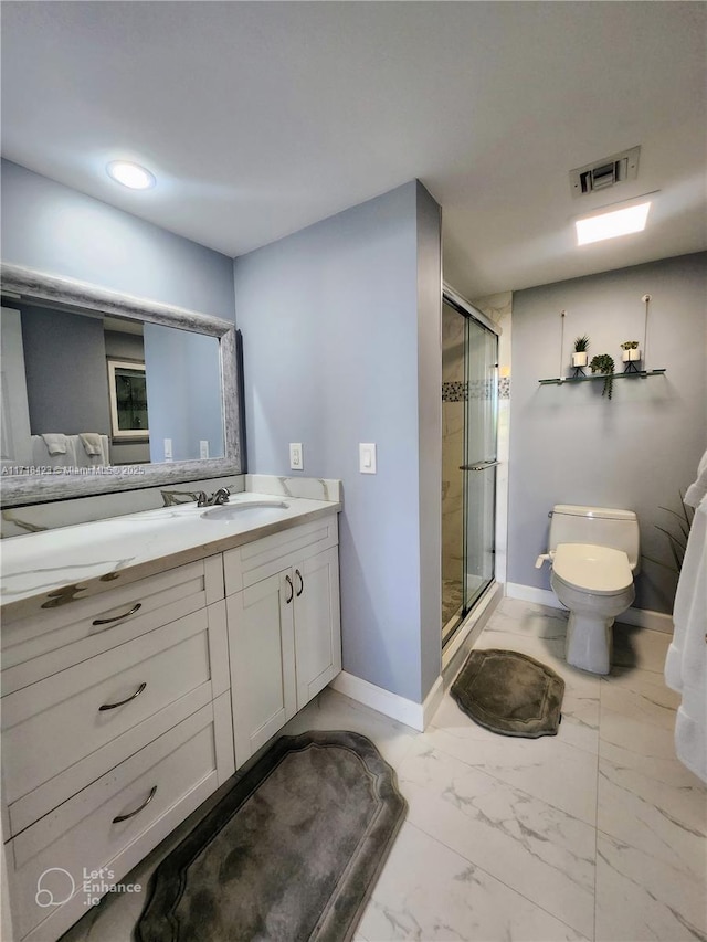 bathroom with vanity, toilet, and a shower with door