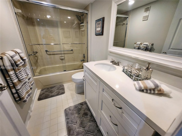 full bathroom featuring tile patterned floors, vanity, toilet, and shower / bath combination with glass door