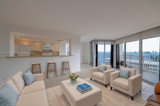 4000 Towerside Ter Unit 908, Miami, FL 33138 - living room featuring light tile patterned floors, a wall of windows, and recessed lighting