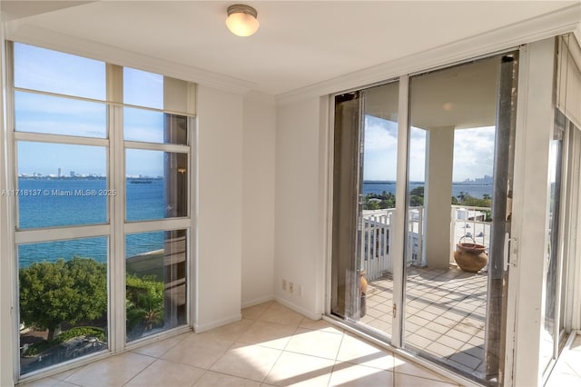 4000 Towerside Ter Unit 908, Miami, FL 33138 - doorway featuring a water view, light tile patterned floors, and ornamental molding
