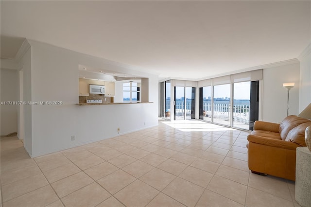4000 Towerside Ter Unit 908, Miami, FL 33138 - living room with ornamental molding, light tile patterned floors, plenty of natural light, expansive windows, and a water view