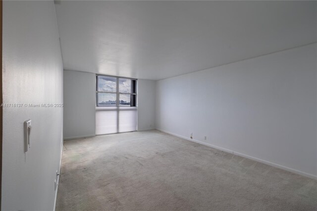4000 Towerside Ter Unit 908, Miami, FL 33138 - carpeted empty room with baseboards