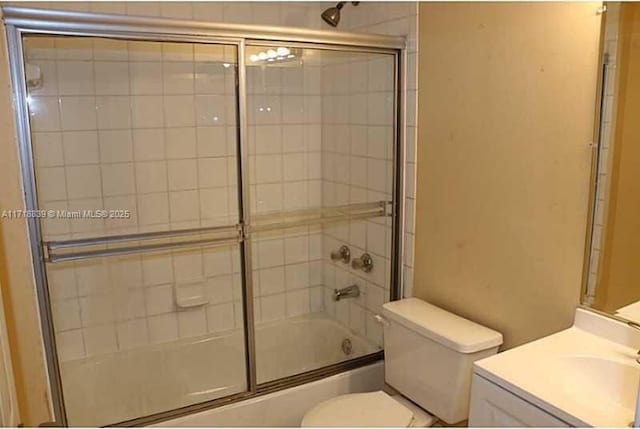 full bathroom with toilet, vanity, and combined bath / shower with glass door