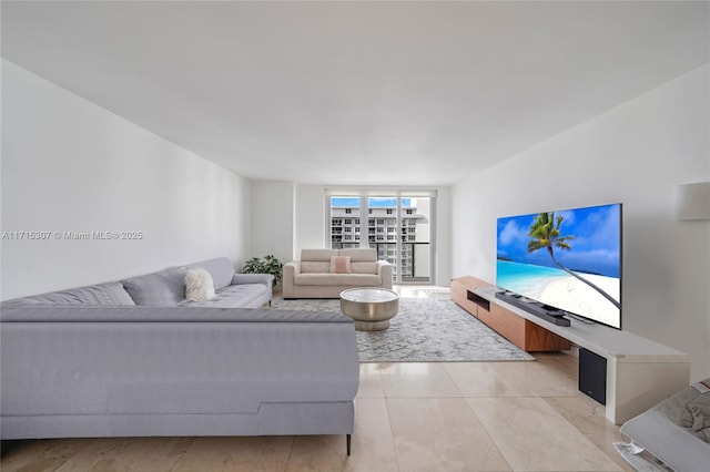 living room featuring light tile patterned flooring and a wall of windows