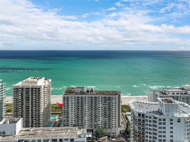 birds eye view of property with a view of the beach and a water view