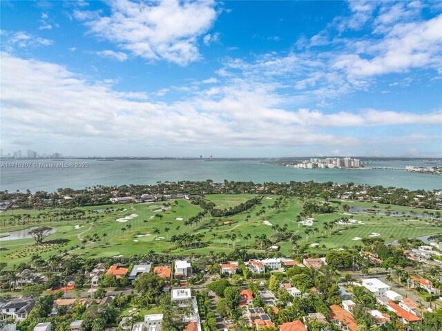 birds eye view of property with golf course view, a water view, and a residential view