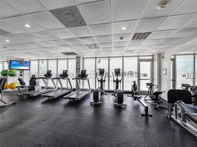 workout area featuring recessed lighting, visible vents, and a healthy amount of sunlight