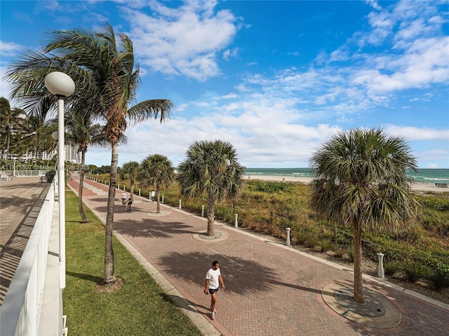 view of home's community with a water view and a view of the beach