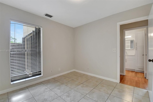 unfurnished room featuring light tile patterned floors