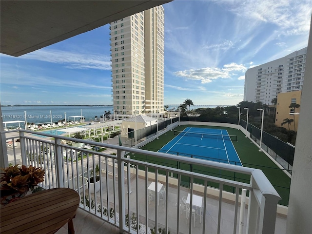 exterior space featuring a water view and tennis court