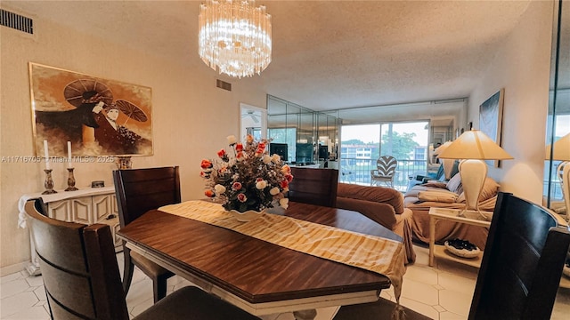 dining area featuring light tile patterned floors, a textured ceiling, and a notable chandelier