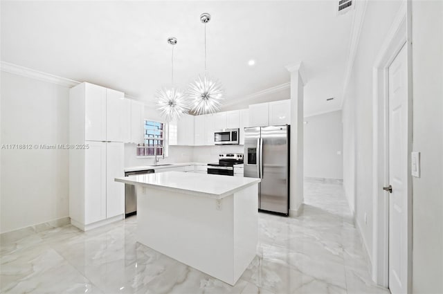 kitchen featuring white cabinets, a center island, appliances with stainless steel finishes, and pendant lighting