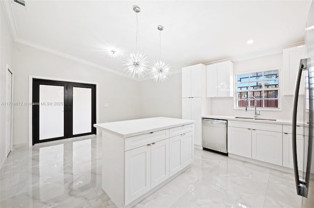 kitchen featuring sink, white cabinets, hanging light fixtures, and appliances with stainless steel finishes