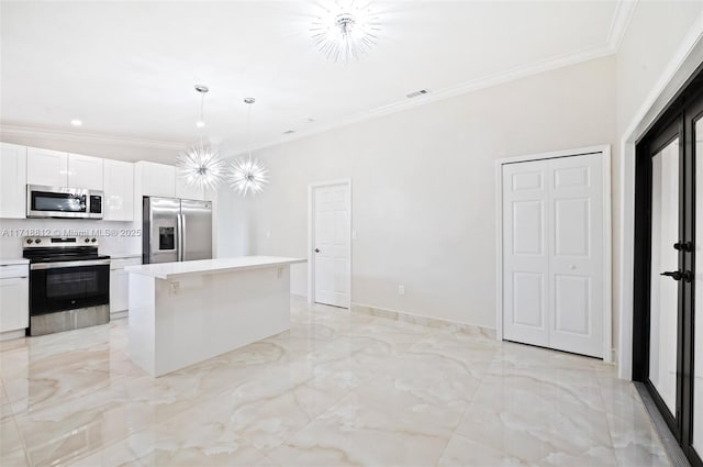 kitchen with ornamental molding, stainless steel appliances, decorative light fixtures, white cabinets, and a kitchen island