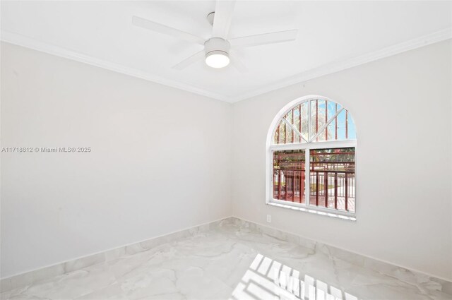 empty room with ceiling fan and crown molding