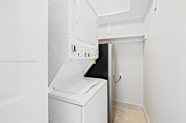 washroom featuring stacked washer and clothes dryer