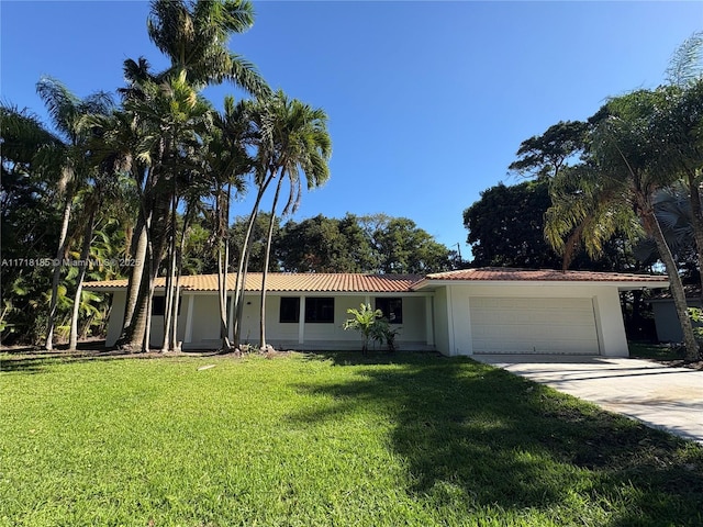 single story home featuring a front yard and a garage