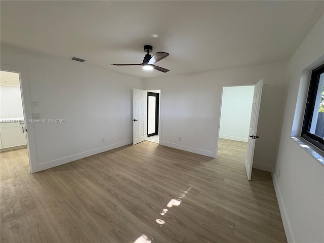 empty room featuring ceiling fan and light hardwood / wood-style floors