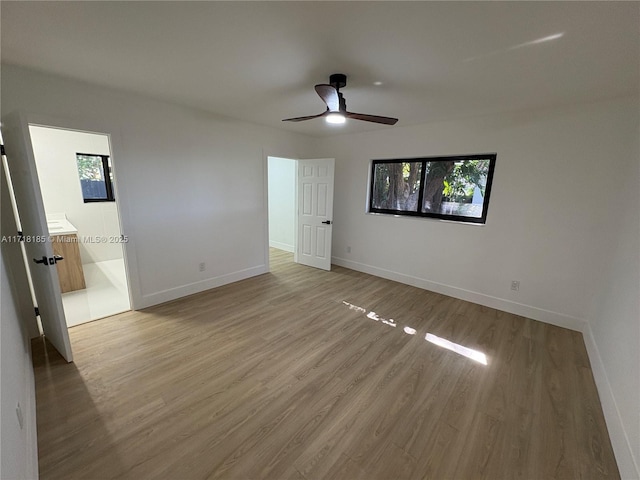 empty room with ceiling fan and light hardwood / wood-style floors