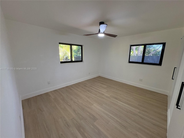 spare room with ceiling fan and light hardwood / wood-style flooring