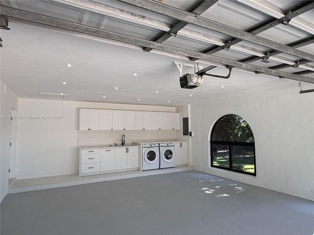 laundry room featuring electric panel, sink, and washer and dryer