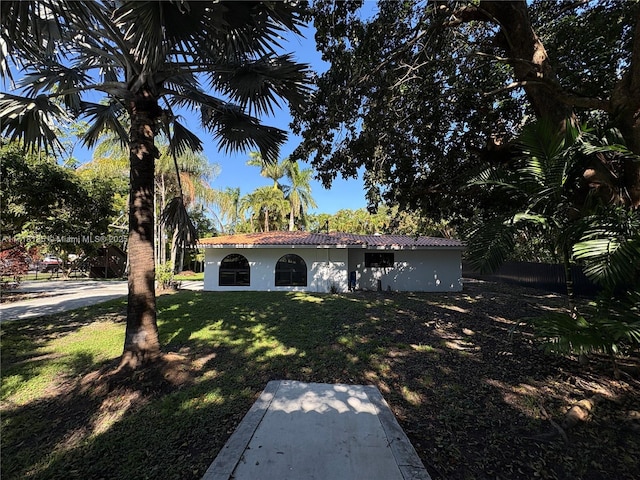 mediterranean / spanish-style home featuring a front yard