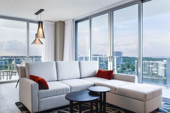 living room featuring expansive windows and a wealth of natural light