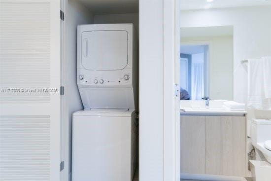 laundry area featuring stacked washer and clothes dryer