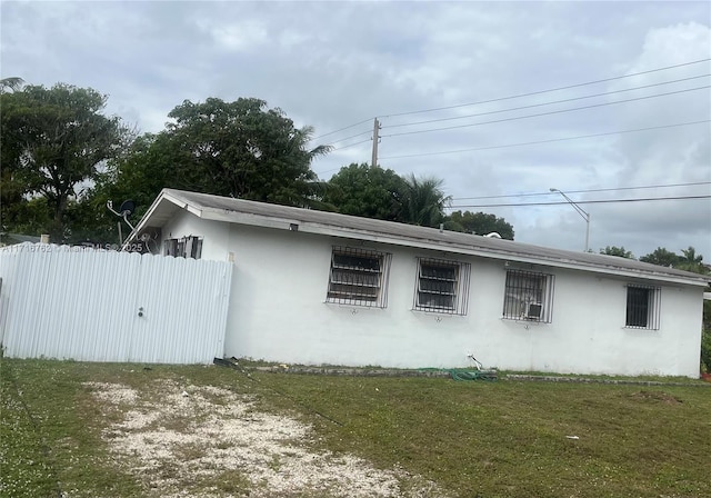 view of side of property with a yard