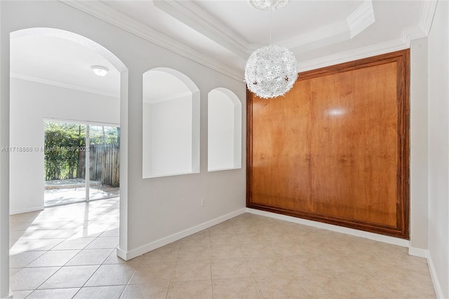 unfurnished room featuring a raised ceiling, ornamental molding, light tile patterned floors, and a chandelier