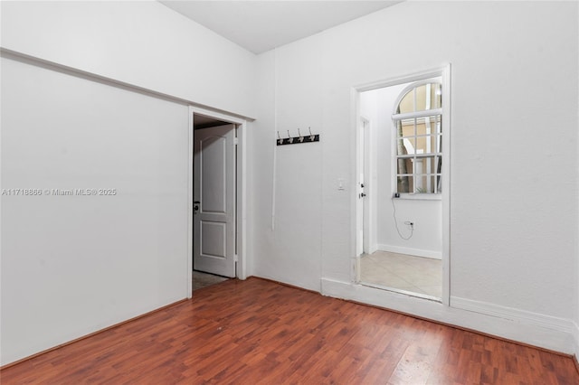 unfurnished room with hardwood / wood-style flooring