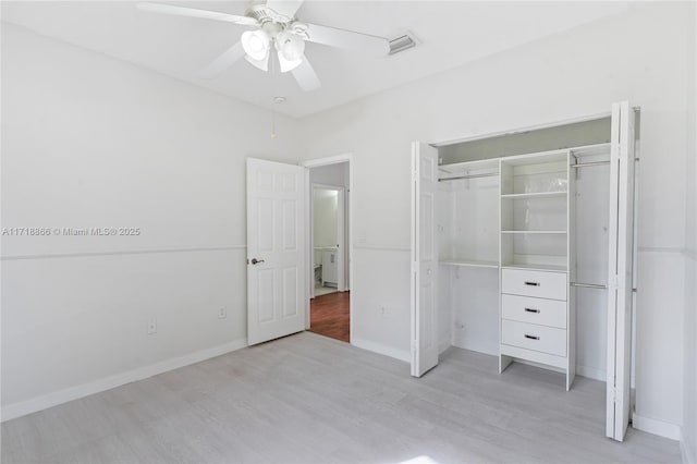 unfurnished bedroom with a closet, light hardwood / wood-style flooring, and ceiling fan