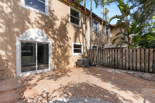 rear view of house featuring a patio and cooling unit