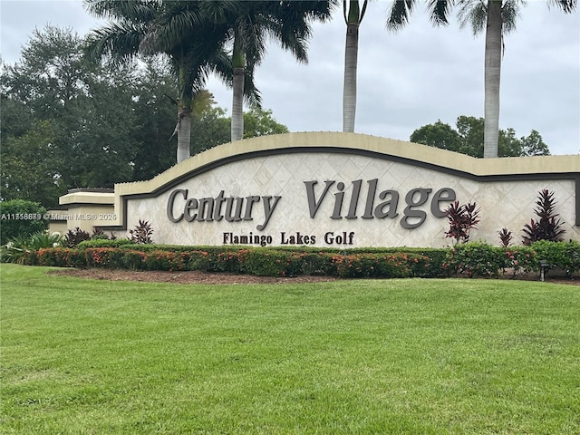 community sign featuring a yard