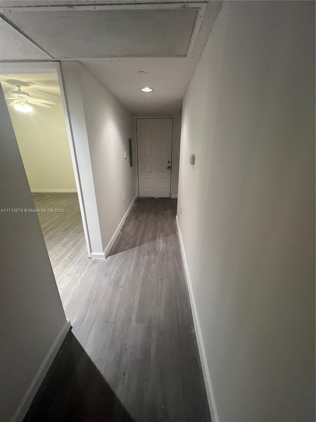 hallway with hardwood / wood-style flooring