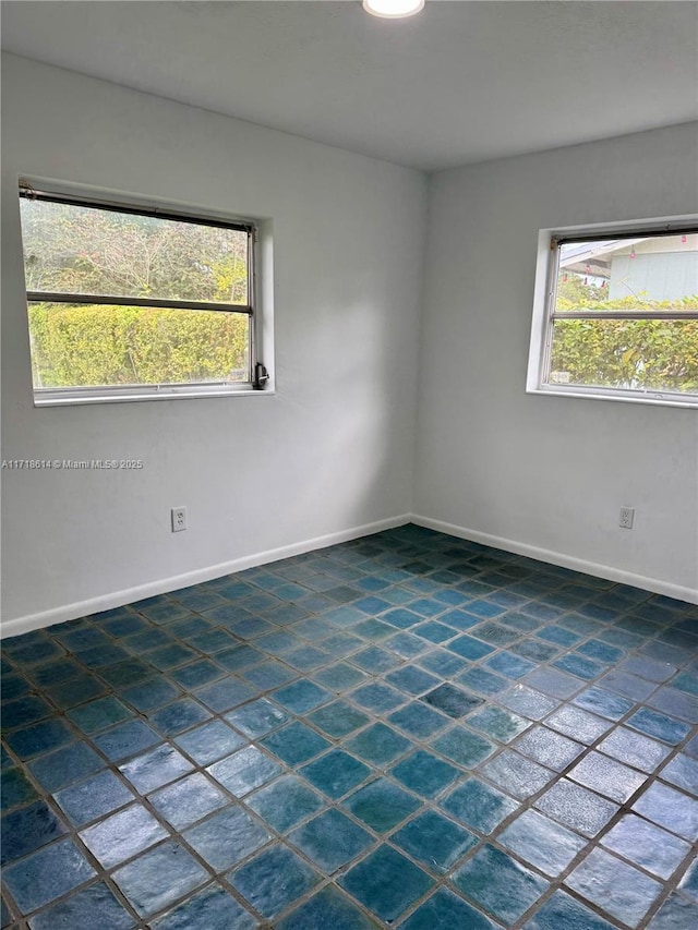 unfurnished room featuring plenty of natural light