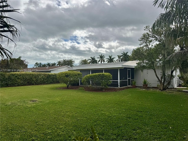 view of yard with a sunroom