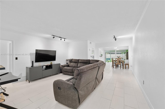 tiled living room featuring track lighting