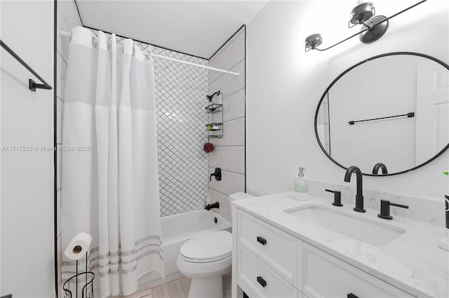 full bathroom featuring shower / bath combo, vanity, and toilet