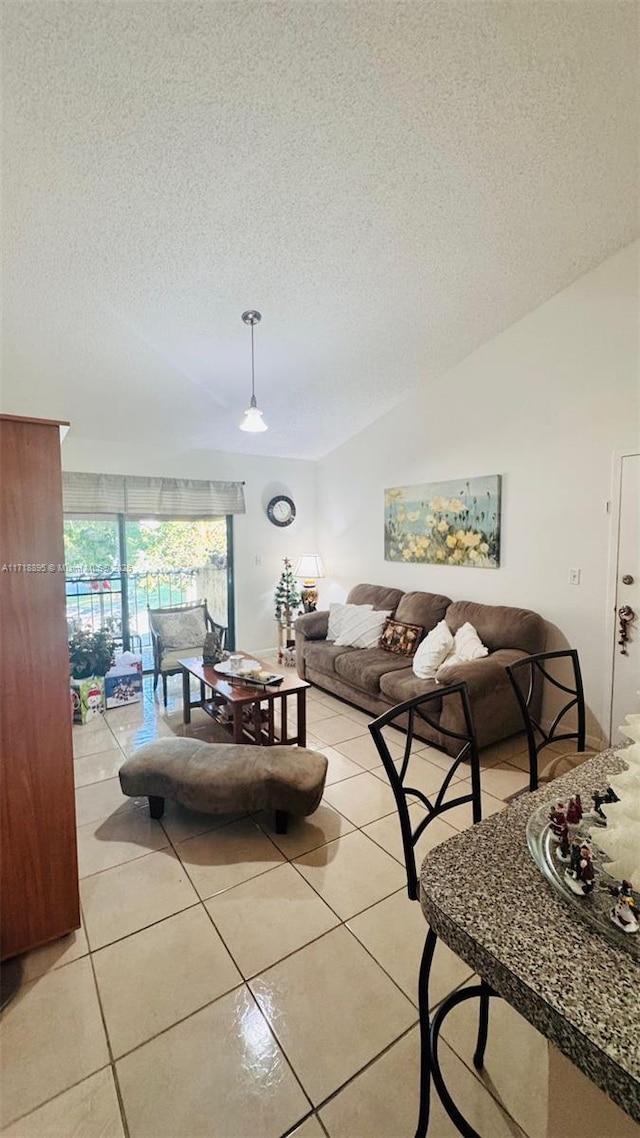 tiled living room featuring a textured ceiling and lofted ceiling