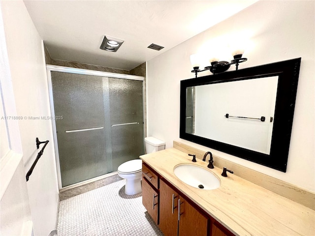 full bath with toilet, visible vents, vanity, a shower stall, and tile patterned floors